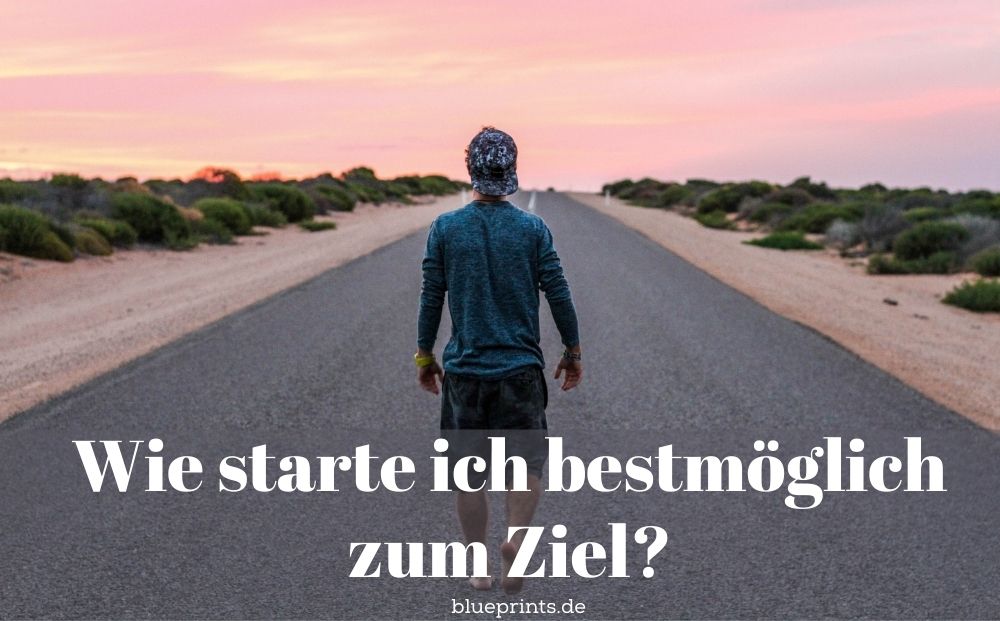Mann steht barfuß auf einer Straße.
